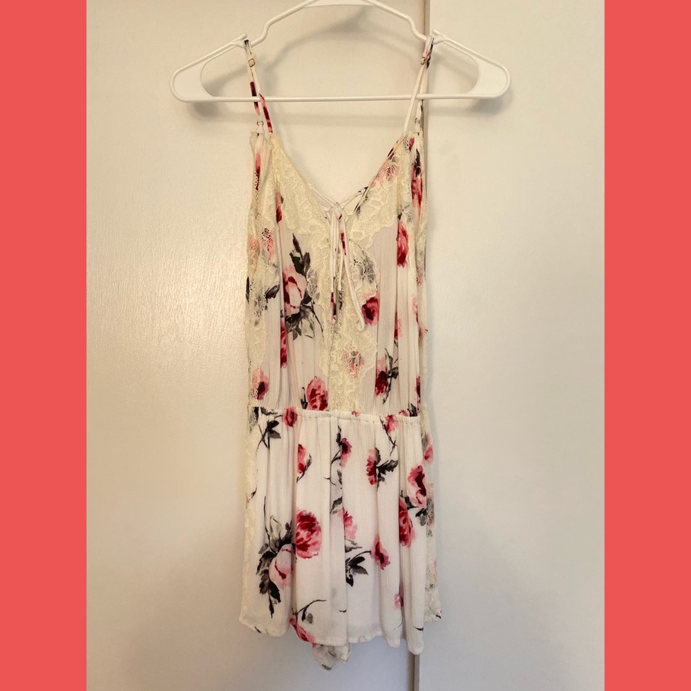 pink and white floral romper with lace detail